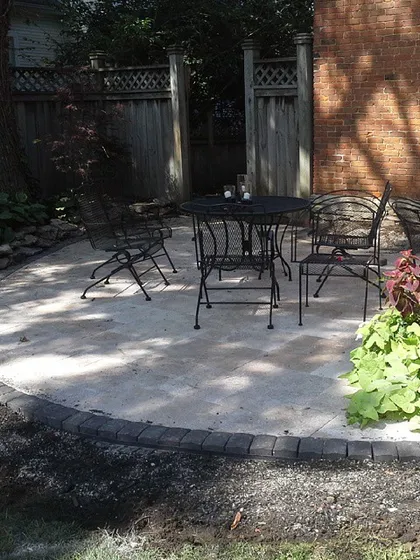 Even a small space can be turned into a useful patio. Here, I laid a simple circular patio with a dark paver border, creating a perfect spot for a small table and chairs.
