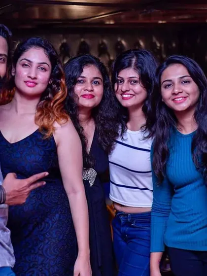 A group of friends posing together on the dance floor. I play a mix of music that brings people together for a fun night out.