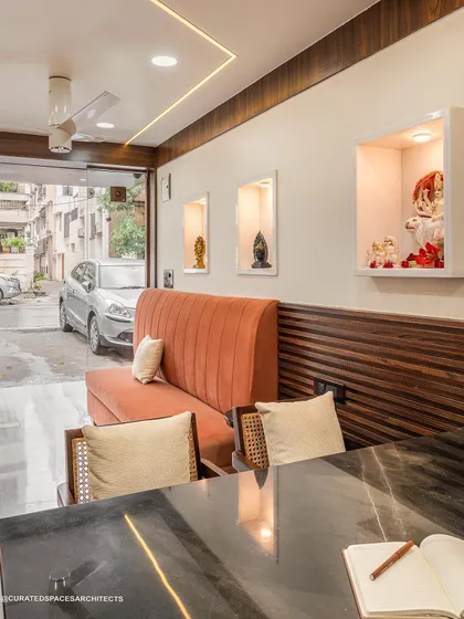 From this angle, you can see the custom display niches for decor and the large glass door that brings in natural light. The layout is designed for a smooth client flow and a welcoming atmosphere, even in a narrow space.