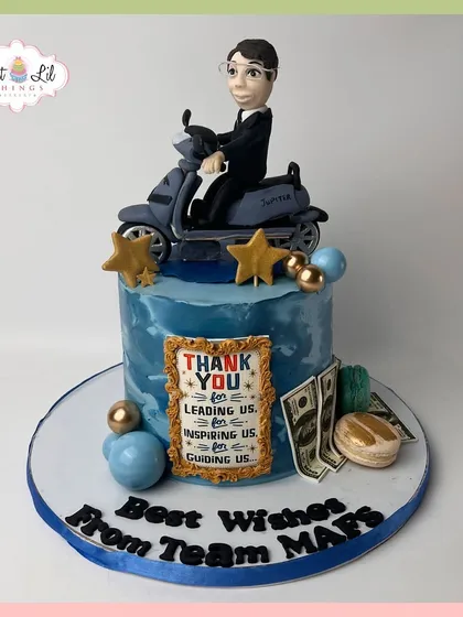 A thank you cake for an inspiring leader, featuring a custom figurine on a scooter, an appreciation plaque, and other personal details.