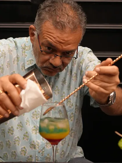 Who says you can't learn new tricks? Our mixology workshops are for everyone, regardless of age or experience. This participant is completely focused on mastering the art of layering, proving that a passion for great cocktails has no age limit.