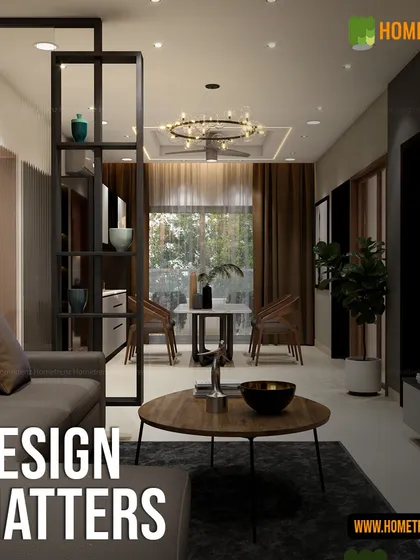 Good design matters. Here, an open-shelf partition defines the dining area without closing it off, while the ring chandelier acts as a centerpiece, proving that functional elements can also be the most beautiful.
