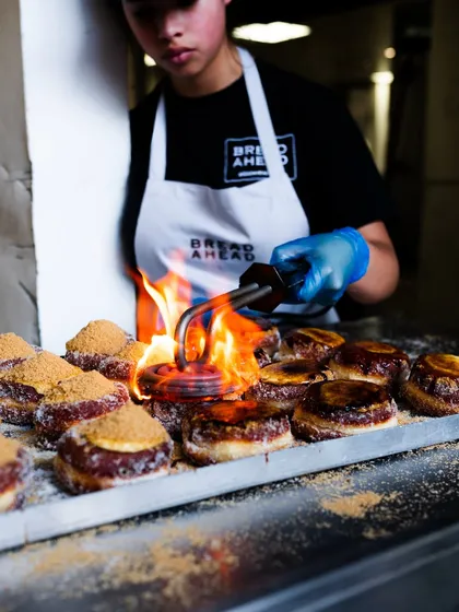 Fire adds so much drama to food photography. Here, I captured the moment a blowtorch caramelizes the sugar on donuts at Bread Ahead Bakery, creating a visually exciting and appetizing action shot.