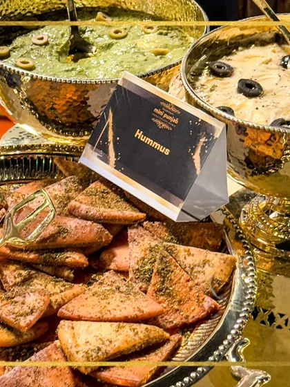 Our hummus and pita bread station, featuring different varieties of creamy hummus served in elegant golden bowls. It's a perfect taste of the Mediterranean.