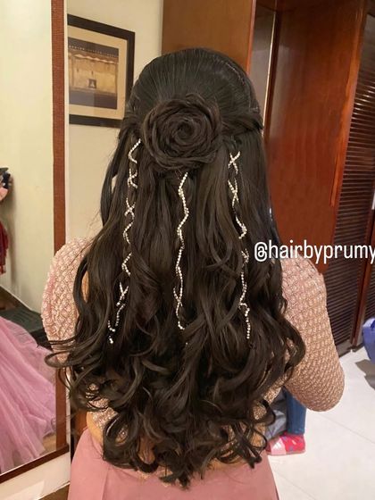 Creating magic with this half-up style featuring a hair rose and cascading diamond accessories. A truly enchanting look.