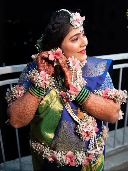 A candid moment of our client adjusting her floral earring. The full set creates a look of effortless grace.