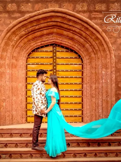 An example of a beautiful Indo-western pre-wedding look. The bride-to-be wears a flowing turquoise gown, while the groom-to-be complements her in a patterned jacket. This is a great rental choice for a unique, modern-ethnic theme.