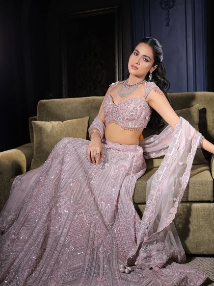 A full-length view of this elegant party look. The pastel lehenga is beautifully complemented by the soft and radiant makeup, suitable for a wedding guest or bridesmaid.