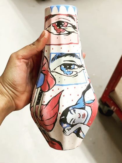 The vase before firing, showing the matte appearance of the underglaze paints.