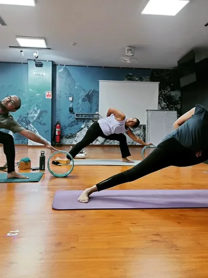 Students using the yoga wheel as a guide in this extended side angle pose variation. Props are wonderful tools to explore alignment and find more space in the body.