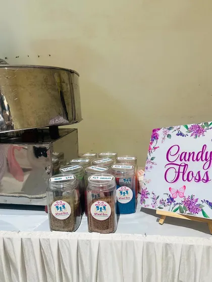 Our flavor station, showcasing the different organic sugars we use to create our unique cotton candy. The setup includes a menu board for easy selection.