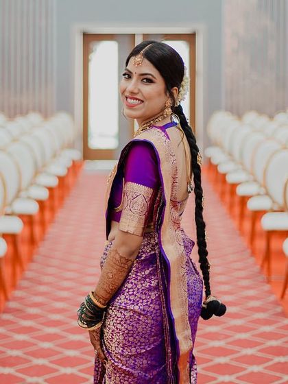 A beautiful shot of the bride looking back with a smile, the long aisle of empty chairs creating a sense of anticipation and a unique composition.