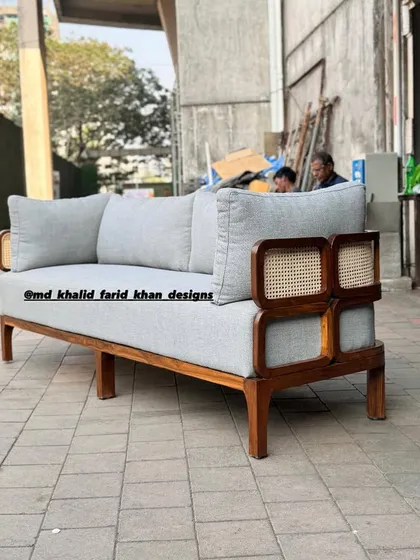 A three-quarter view of the light grey sofa.