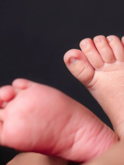 A macro photograph of a newborn's tiny feet. These are the little details that change so quickly in the first few weeks.