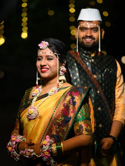 This couple's portrait captures the joy of the Haldi ceremony. The bride's complete floral jewellery set, from her maang tika to hathphool, ties the entire look together.