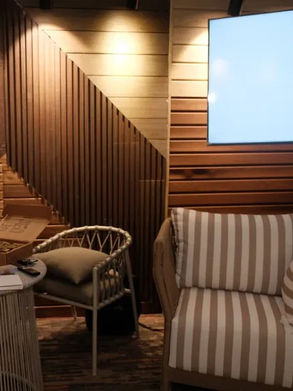 Another view of our Bhubaneswar expo booth, showing our wood-panelled feature wall and a comfortable client consultation area.