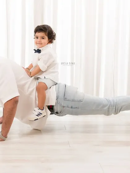 The strength of a father's love. I always encourage fun and playful moments during family sessions. This candid shot of a dad doing a push-up with his son on his back is a perfect example of capturing genuine joy and connection.