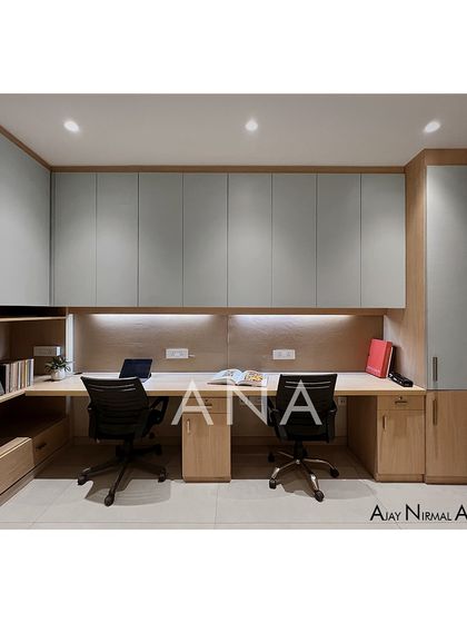 A frontal view of the workstations, designed for simplicity and functionality. Ample overhead storage and under-desk lighting create a clean and efficient workspace.