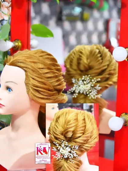 This is an example of the advanced hairstyling techniques I teach at my academy. This intricate updo, created on a mannequin for clarity, shows the detailed work that goes into creating a perfect bridal hairstyle, finished with a delicate hair accessory.