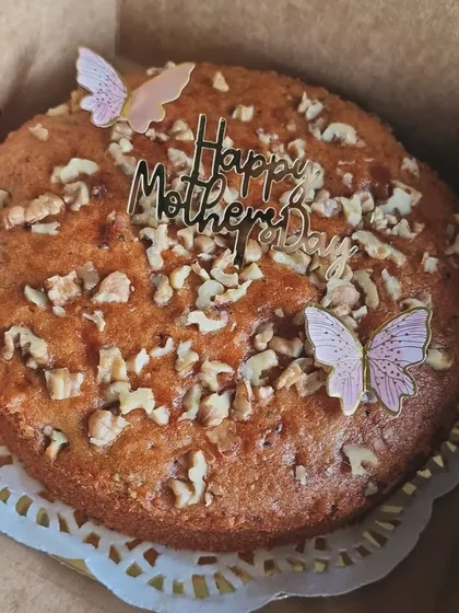 A single Mother's Day walnut cake, packaged and ready for gifting.