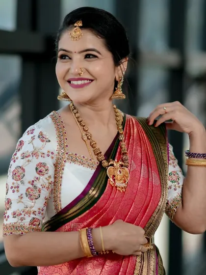 Another view of the white blouse with multi-color floral embroidery. The design adds a playful yet elegant touch to the traditional silk saree.