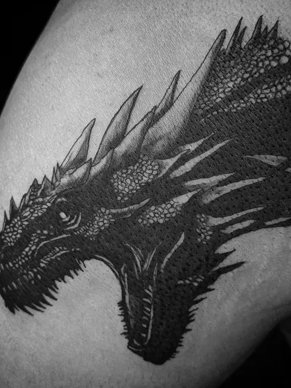 This black and grey tattoo of Balerion the dragon showcases my passion for detailed, high-contrast mythical creatures. I focus on capturing the power and texture in each piece, making it a bold statement.