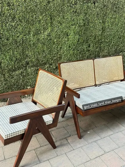 A Pierre Jeanneret inspired set with checked fabric cushions.