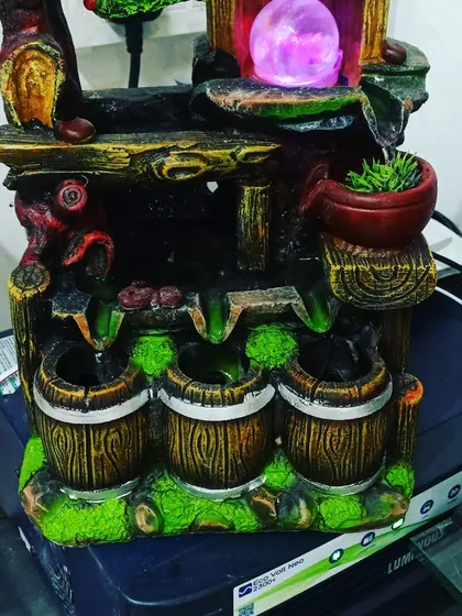 This rustic-style fountain is designed to look like wooden barrels and includes a small planter for a succulent or air plant.
