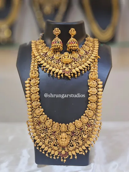 Feel like a goddess on your special day with our intricate temple jewellery. This full bridal set includes a choker and a long haar, both featuring detailed carvings of deities like Goddess Lakshmi, finished in an antique gold polish. This is a very popular choice for South Indian bridal looks and traditional ceremonies.