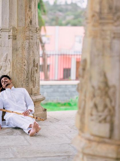 A candid, relaxed moment as the couple rests at the base of ancient temple pillars. These unposed shots capture the quiet, comfortable moments of a relationship.