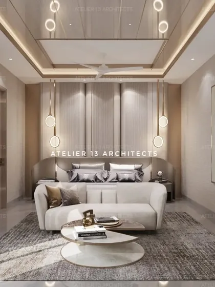 We used sweeping curves in the wall paneling and headboard of this bedroom to create a soft and elegant design. The room features a chic sofa at the foot of the bed and state-of-the-art lighting for a modern, curated feel.