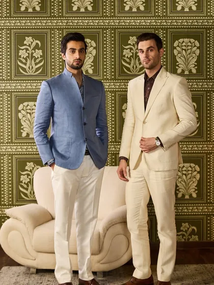 A full-length shot of the two groomsmen, demonstrating how different styles in a coordinated color palette can create a polished and harmonious look for the wedding party.