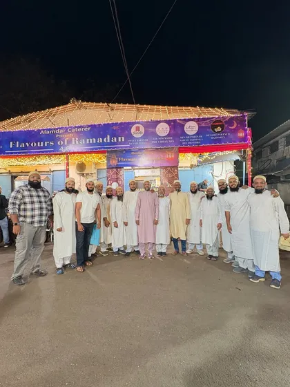 A large group of men posing for a photo. We are happy to host you all.