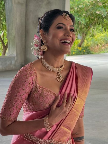 The beautiful Shwetha Prasad in a lotus pink Kanchivaram saree. I designed a custom blouse with delicate embroidery to match, creating a soft and romantic look.