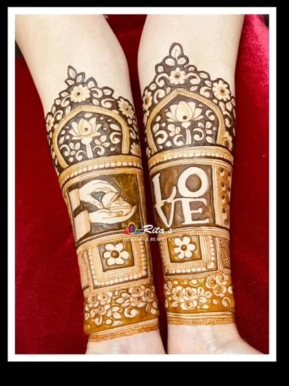 The arm design for a 25th-anniversary mehendi, featuring the word 'LOVE' and symbols of commitment.