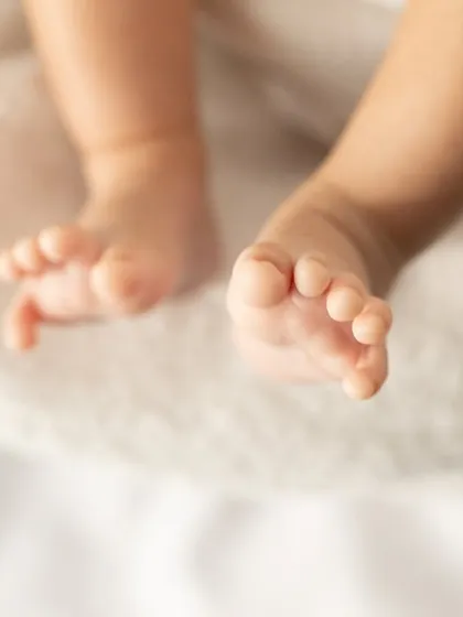 Another beautiful shot of tiny baby toes. The soft lighting and simple background keep the focus on this precious detail.
