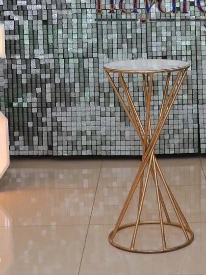 Elegant spiral pedestals used in an anniversary setup, perfect for holding a cake, champagne, or photos.