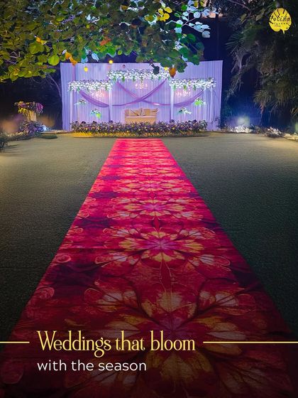 A beautiful floral carpet leads the way to a simple yet elegant reception stage. Our outdoor wedding setups are designed to bloom with the beauty of the season.