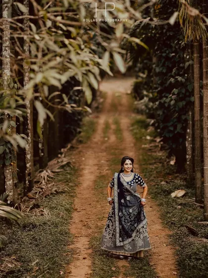 A beautiful solo portrait of the bride-to-be during her pre-wedding shoot. The natural framing of the trees and the soft, earthy tones create a serene and timeless photograph.