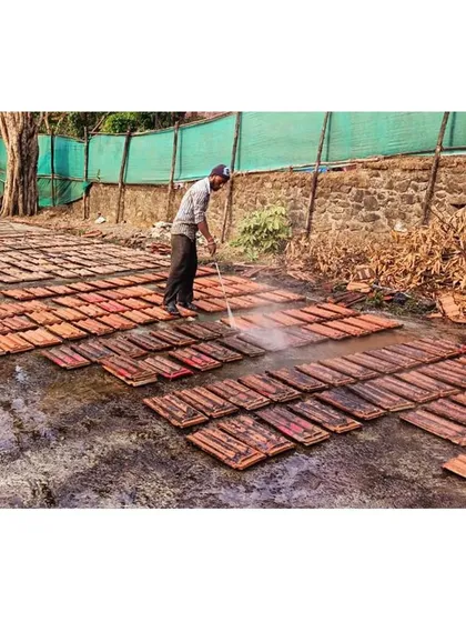 A moment from our restoration process, where salvaged roof tiles are carefully cleaned and prepared for reuse. We prioritize using original materials wherever possible, ensuring that a piece of the past remains embedded in the renewed structure.