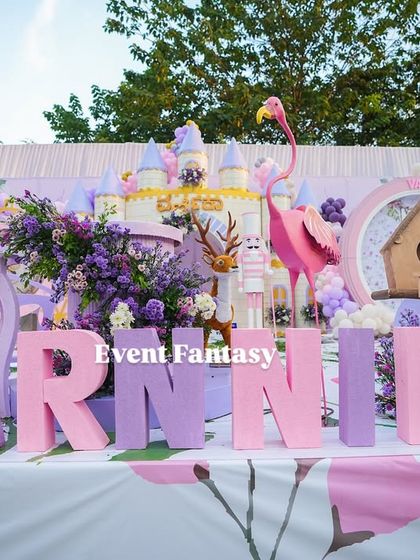 A close-up of the custom "VARNNIKA" name blocks in pink and purple, a key feature of her fairyland stage.