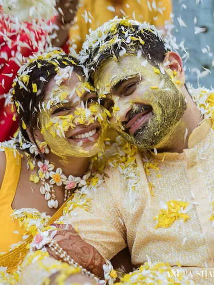 This is what pure joy looks like. I live for these unscripted moments during the Haldi ceremony, where the couple is just lost in laughter, covered in turmeric and flower petals. It's candid, vibrant, and absolutely real.