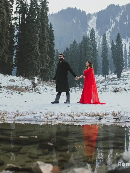 To showcase my destination wedding photography, I took this couple to the snowy landscapes of Kashmir. The striking contrast between the bride's flowing red gown and the pristine white snow creates a visually arresting image that tells a story of adventurous love.