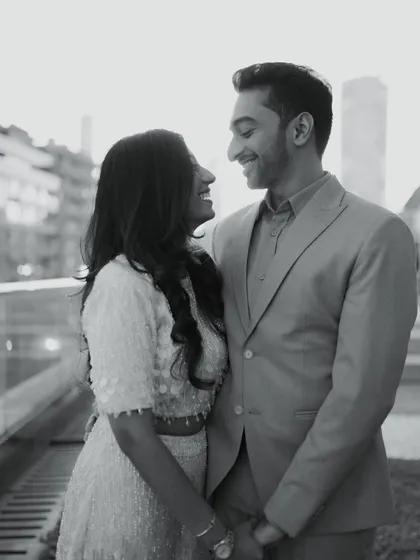 A classic black and white portrait from an urban shoot. The soft light and genuine smiles create a timeless and romantic image that focuses entirely on the couple's connection.