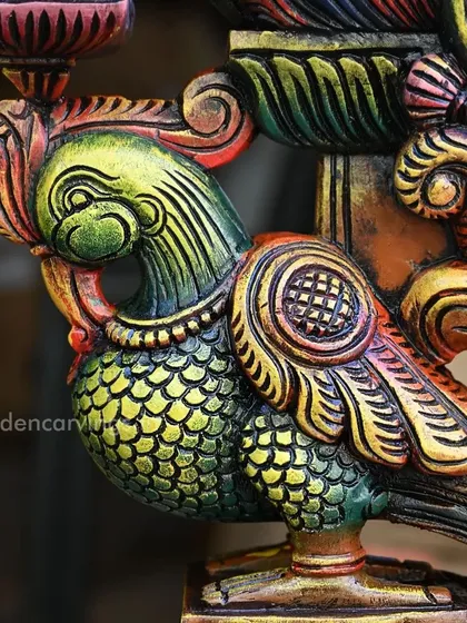 A close-up of the colorful Annapakshi bracket. The painter's skill is evident in the fine lines and shading that define the bird's feathers and form.