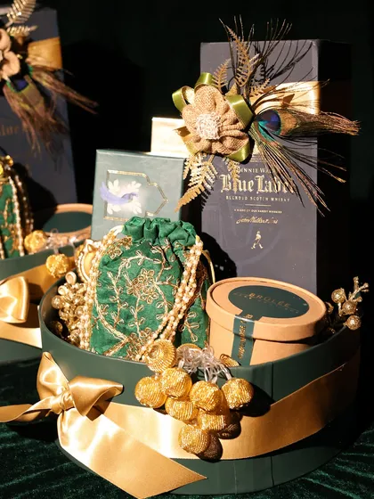For high-end corporate gifting, I curate luxury hampers that make a lasting impression. This one for DC Group features a bottle of Johnnie Walker Blue Label, paired with elegant decor and gourmet treats in a custom green and gold theme.