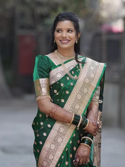 A candid, happy moment captured outdoors. The natural makeup look enhances her features without feeling heavy, making her look effortlessly beautiful for her engagement day.