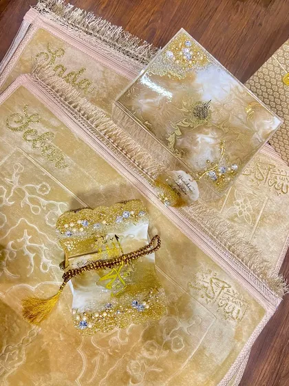 This is one of my most requested prayer sets, shown here in a beautiful golden-beige color. The set includes a personalized prayer mat, a resin Quran box and holder with intricate details, and a matching car hanging.