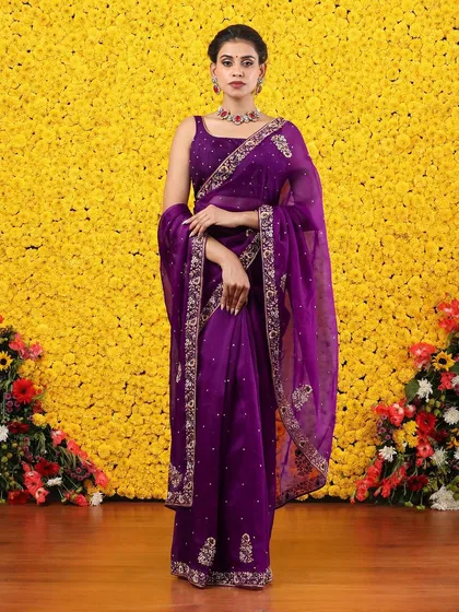 The full, standing view of the embroidered purple organza saree, a true statement piece.