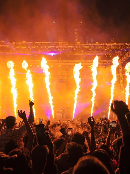 The crowd's hands in the air as fire jets erupt from the stage during the sold-out Martin Garrix show.